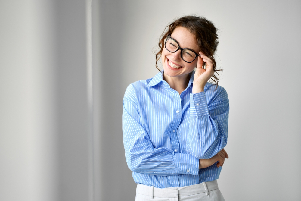 Happy young smiling professional business woman - Eye Exams in Grand Rapids MI